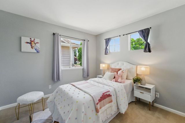 a bedroom with a bed and a lamp