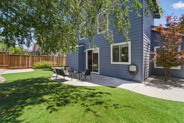 a view of a chairs and table in backyard