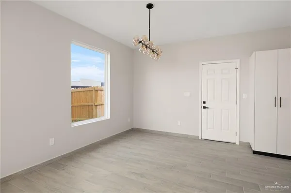 an empty room with windows and closet