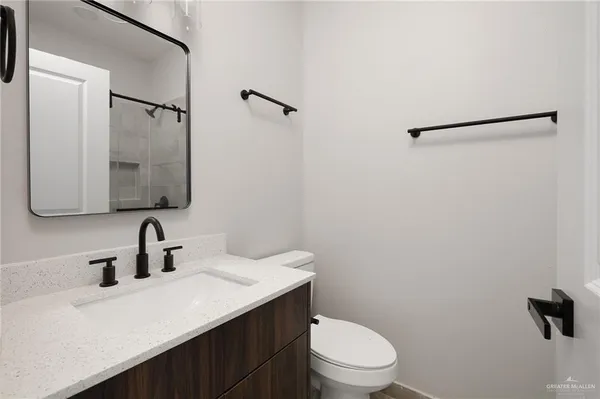 a bathroom with a sink toilet and mirror
