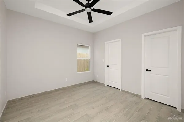 a view of a room with a ceiling fan and a window