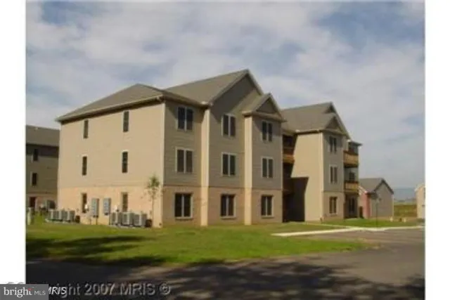 a front view of building with yard