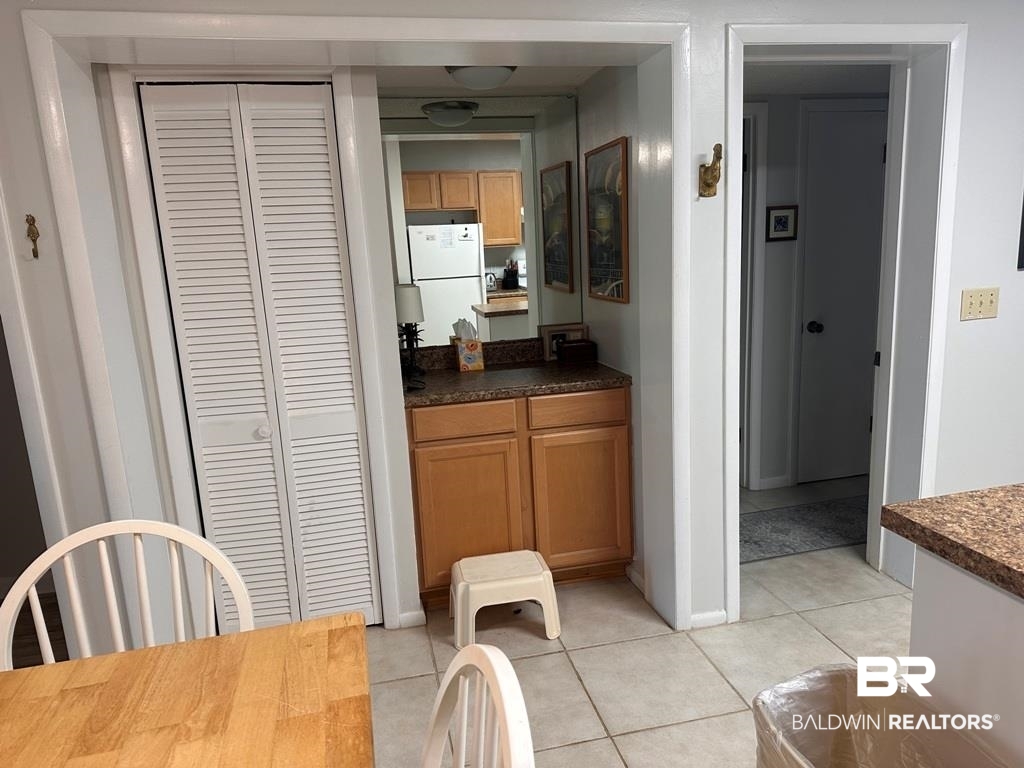 400 Plantation Road, Unit 1113 Gulf Shores, AL 36542 - Photo 6 of 26 Interior space with white fridge and light tile patterned flooring