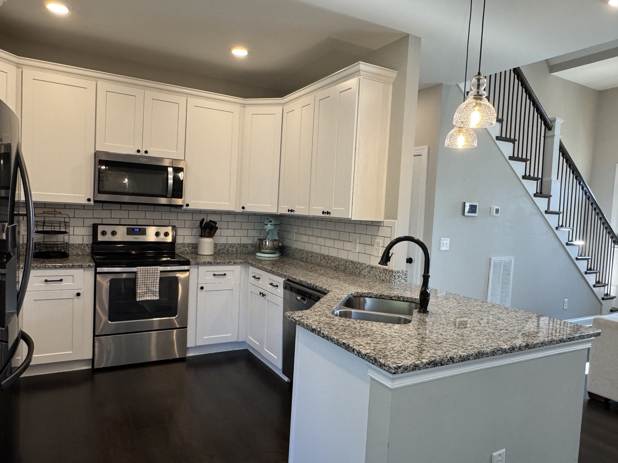 344 Brandywine Lane Springfield, TN 37172 - Photo 13 of 30 a kitchen with granite countertop a sink and a stove top oven with white cabinets