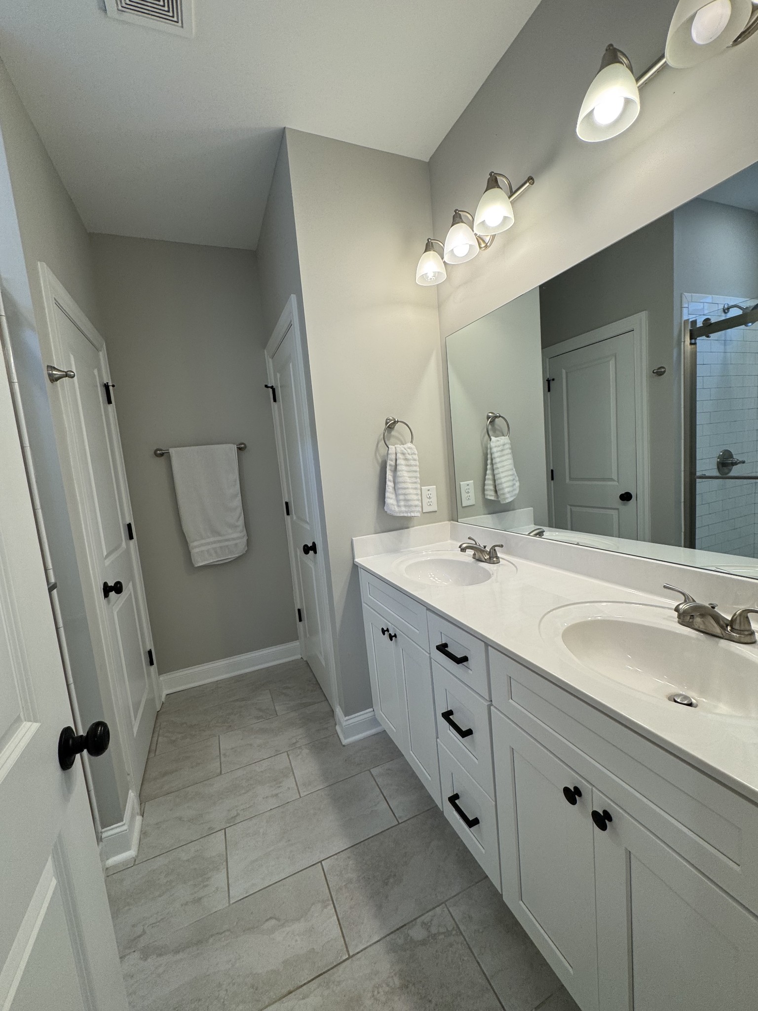 344 Brandywine Lane Springfield, TN 37172 - Photo 10 of 30 a spacious bathroom with a double vanity sink a mirror and a shower