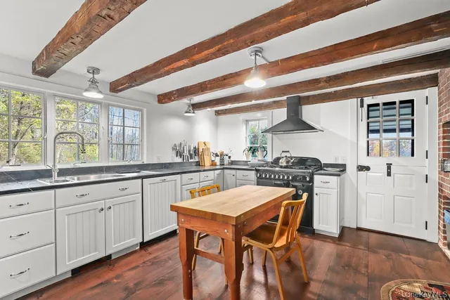 a kitchen with stainless steel appliances granite countertop a stove a sink dishwasher and a refrigerator with wooden floor