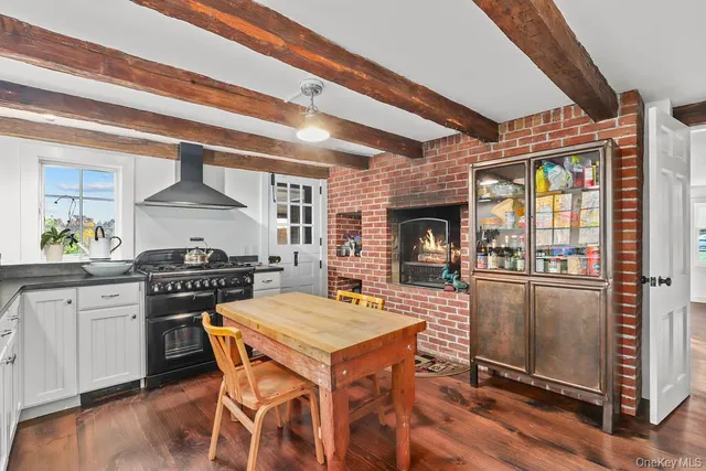 a kitchen with a table chairs stove and cabinets