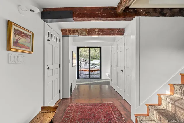 a view of a hallway with wooden floor and a fireplace