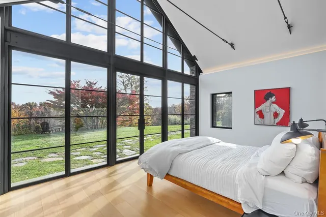 a bedroom with a large bed and a large window