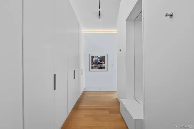 a view of a hallway with wooden floor