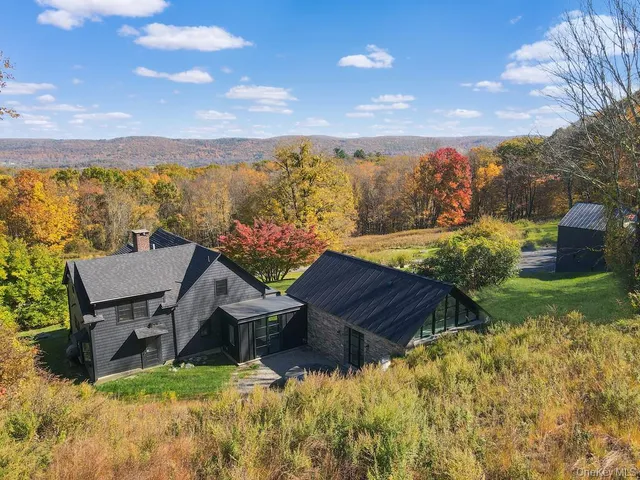 a view of a chairs in backyard of the house