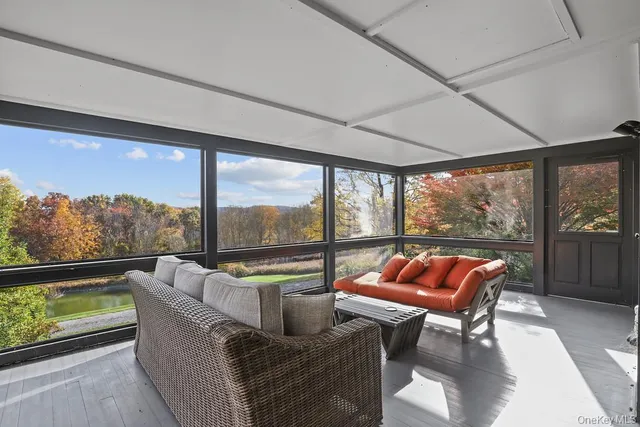 a outdoor living space with furniture and a floor to ceiling window