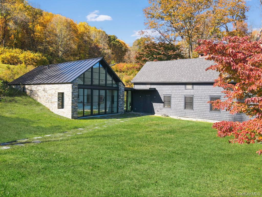 56 Northrup Road Dover Plains, NY 12522 - Photo 5 of 44 a front view of a house with a garden and yard