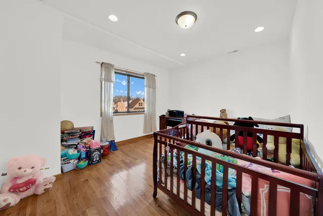 a bedroom with furniture and baby crib
