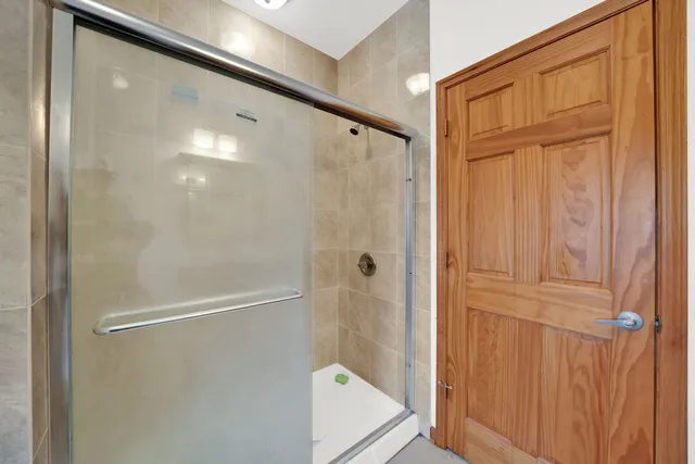 a bathroom with a glass shower door