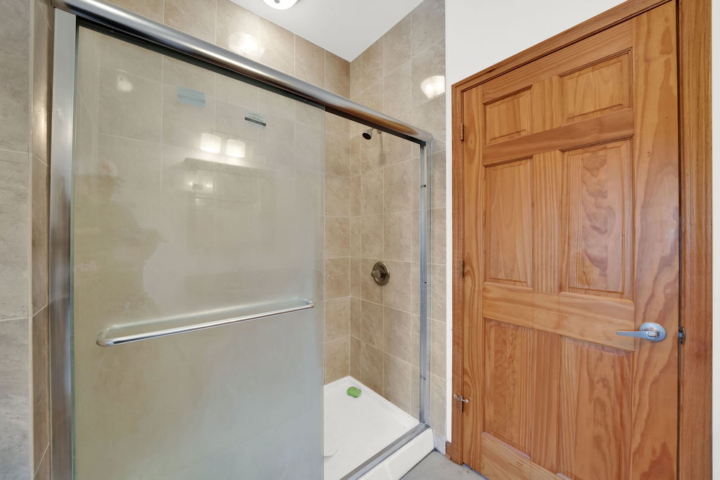 3917 West 60th Street Chicago, IL 60629 - Photo 18 of 34 a bathroom with a glass shower door