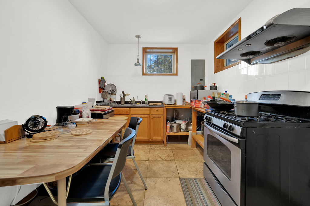 3917 West 60th Street Chicago, IL 60629 - Photo 25 of 34 a kitchen with granite countertop a stove a sink and a refrigerator