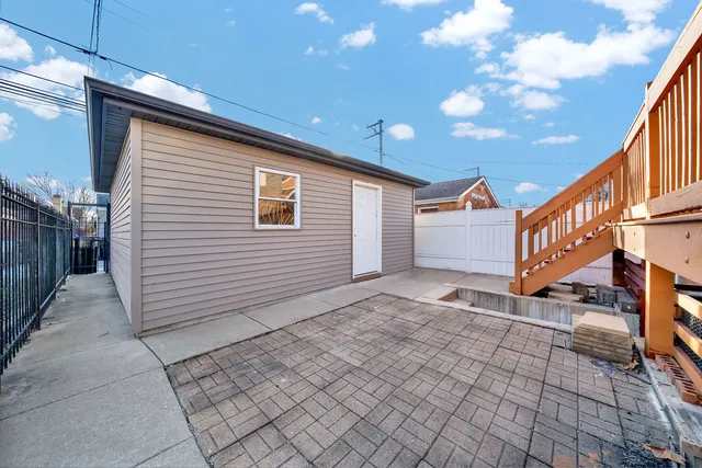 a view of a house with iron fence
