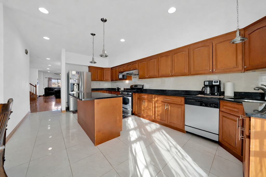 3917 West 60th Street Chicago, IL 60629 - Photo 9 of 34 a kitchen with stainless steel appliances granite countertop a refrigerator a sink and a stove