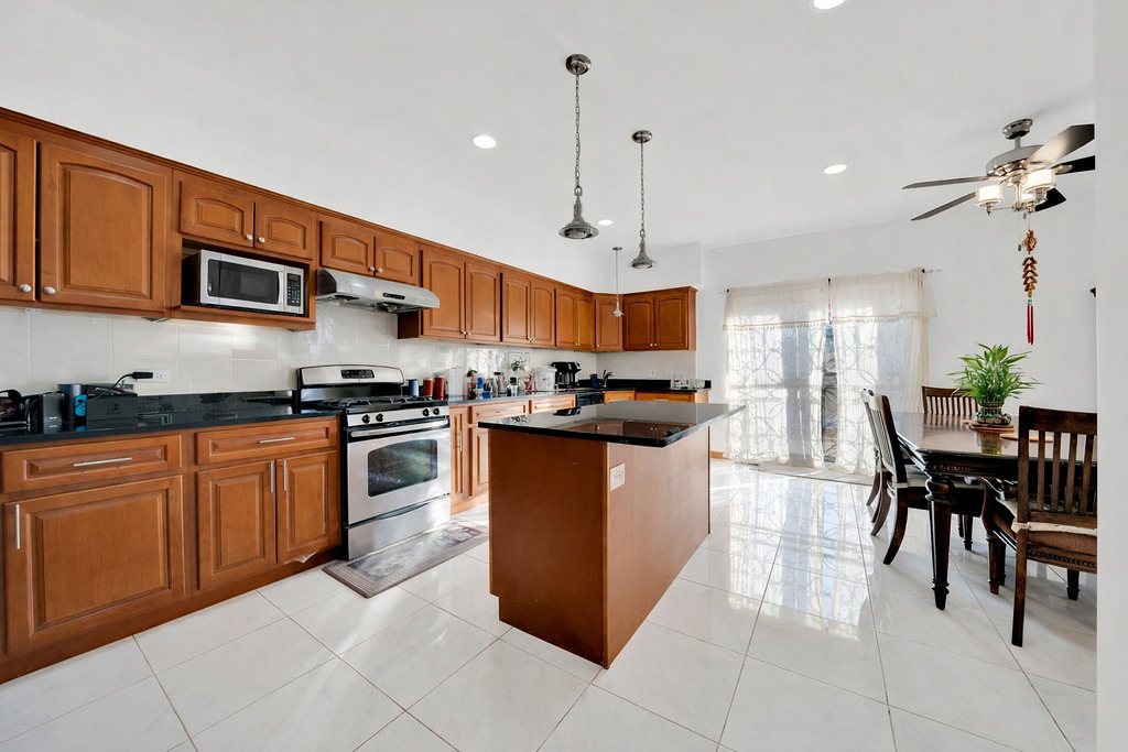 3917 West 60th Street Chicago, IL 60629 - Photo 10 of 34 a kitchen with stainless steel appliances granite countertop a stove a sink a microwave and a refrigerator