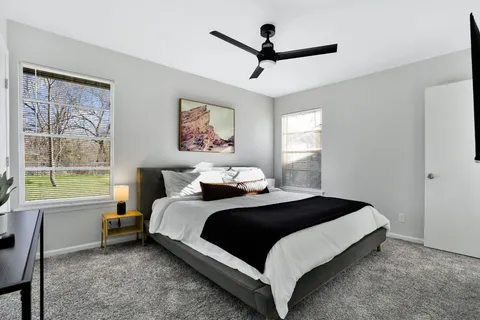 a bedroom with a large bed and a window