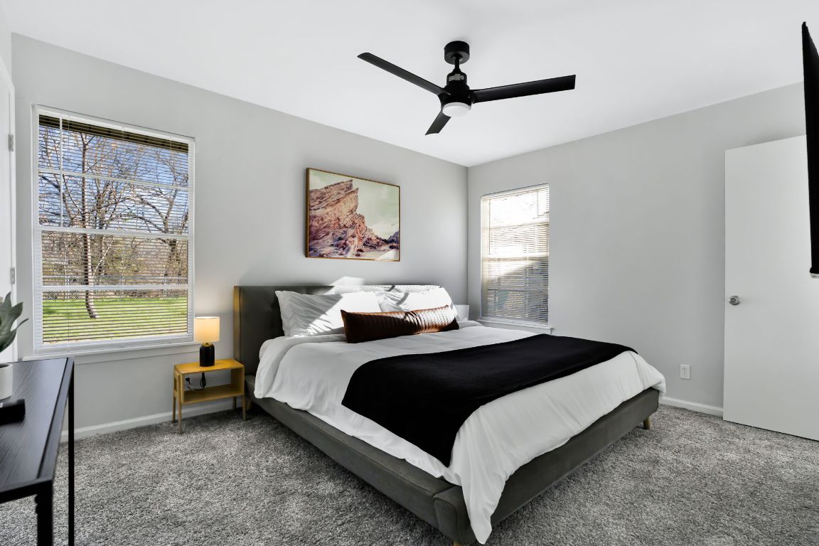 1205 Arthur Stiles Road Austin, TX 78721 - Photo 12 of 20 a bedroom with a large bed and a window