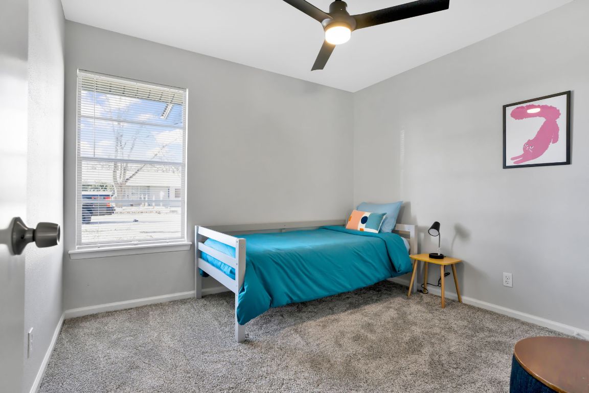 1205 Arthur Stiles Road Austin, TX 78721 - Photo 15 of 20 a bedroom with a bed and a window