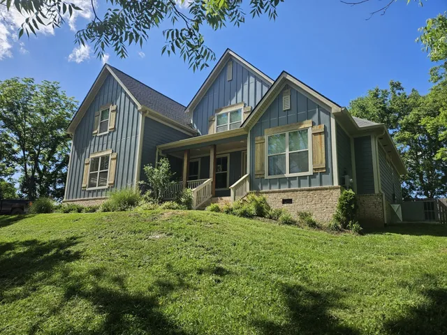 a front view of a house with a yard and porch