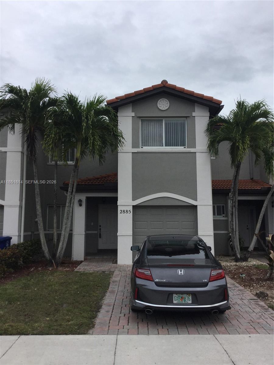 2885 Southwest 127th Avenue Miramar, FL 33027 - Photo 1 of 13 a front view of a house with a garden