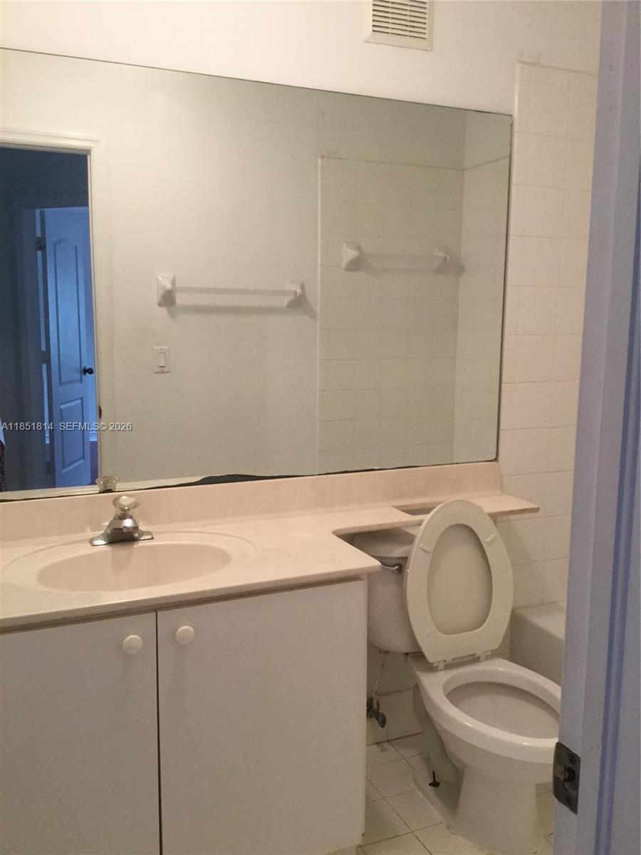 2885 Southwest 127th Avenue Miramar, FL 33027 - Photo 13 of 13 a bathroom with a granite countertop toilet sink and mirror