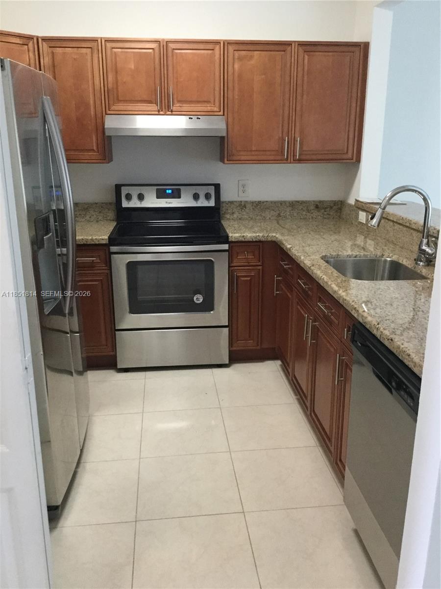 2885 Southwest 127th Avenue Miramar, FL 33027 - Photo 2 of 13 a kitchen with a stove a sink and a refrigerator