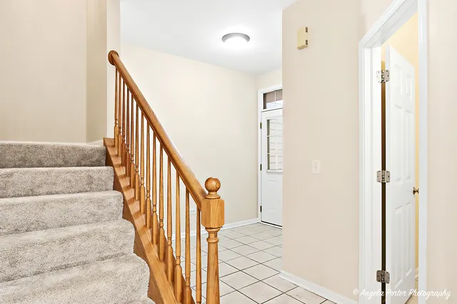 a view of staircase with wooden floor and a large window