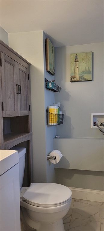 11 Walter Street, Unit 2 Boston, MA 02136 - Photo 14 of 26 a white toilet sitting next to a bathroom sink and vanity