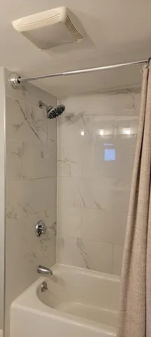 a bathroom with a shower and a sink