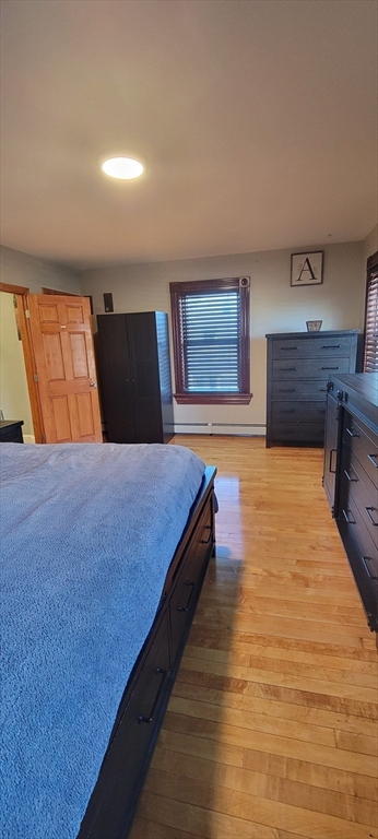 11 Walter Street, Unit 2 Boston, MA 02136 - Photo 18 of 26 a spacious bedroom with a bed and painting on the wall