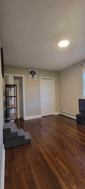 11 Walter Street, Unit 2 Boston, MA 02136 - Photo 21 of 26 a view of an empty room with wooden floor and a window