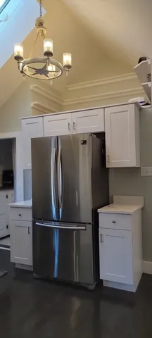 a kitchen with stainless steel appliances a refrigerator and cabinets