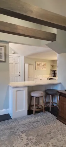 a living room with furniture and a kitchen