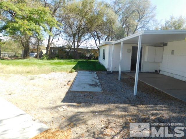 a view of a backyard with large trees