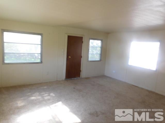 4880 Wayne Drive Sun Valley, NV 89433 - Photo 4 of 11 an empty room with windows