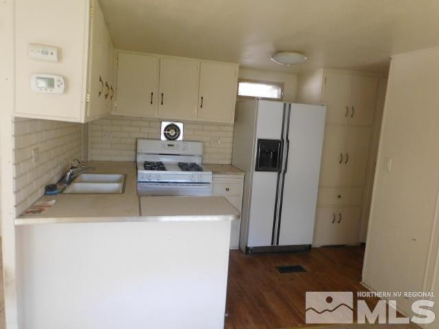4880 Wayne Drive Sun Valley, NV 89433 - Photo 5 of 11 a kitchen with a refrigerator and a sink