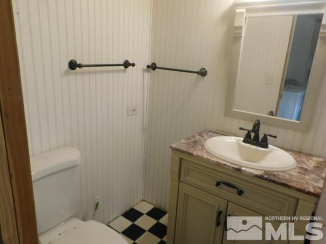 4880 Wayne Drive Sun Valley, NV 89433 - Photo 10 of 11 a bathroom with a granite countertop sink toilet and shower