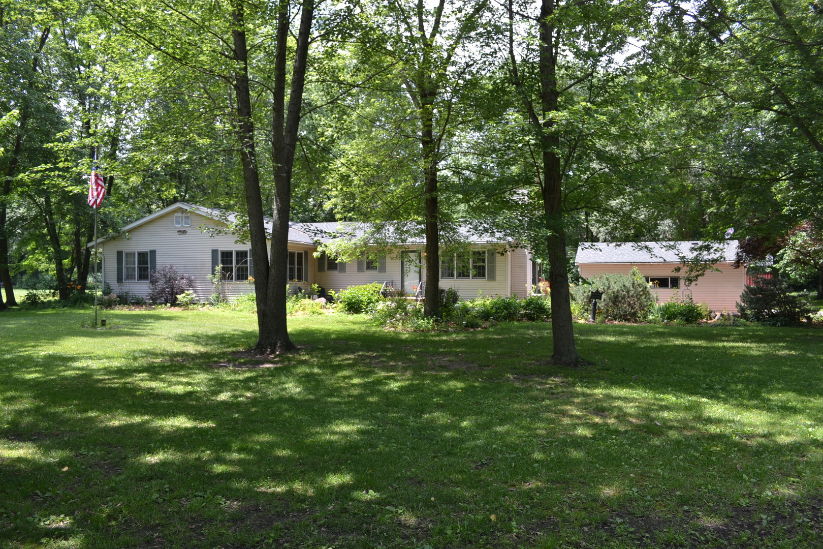a view of a house with a backyard and a tree