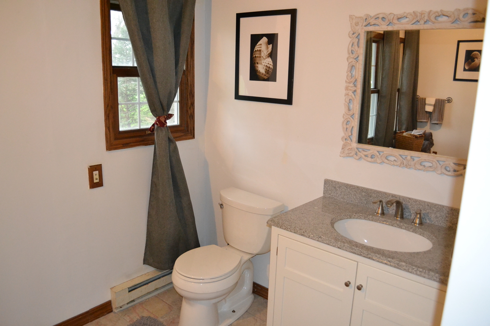 31446 South Kavanaugh Road Wilmington, IL 60481 - Photo 12 of 19 a bathroom with a granite countertop toilet sink and mirror