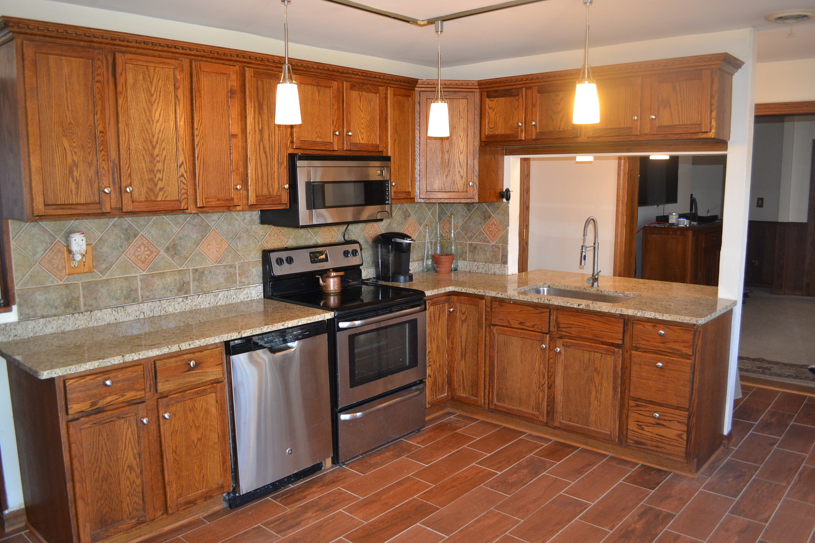 31446 South Kavanaugh Road Wilmington, IL 60481 - Photo 4 of 19 a kitchen with stainless steel appliances granite countertop a stove a sink dishwasher and a refrigerator