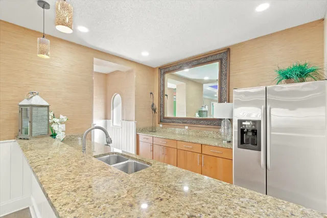 a view of a backyard with plants and swimming pool