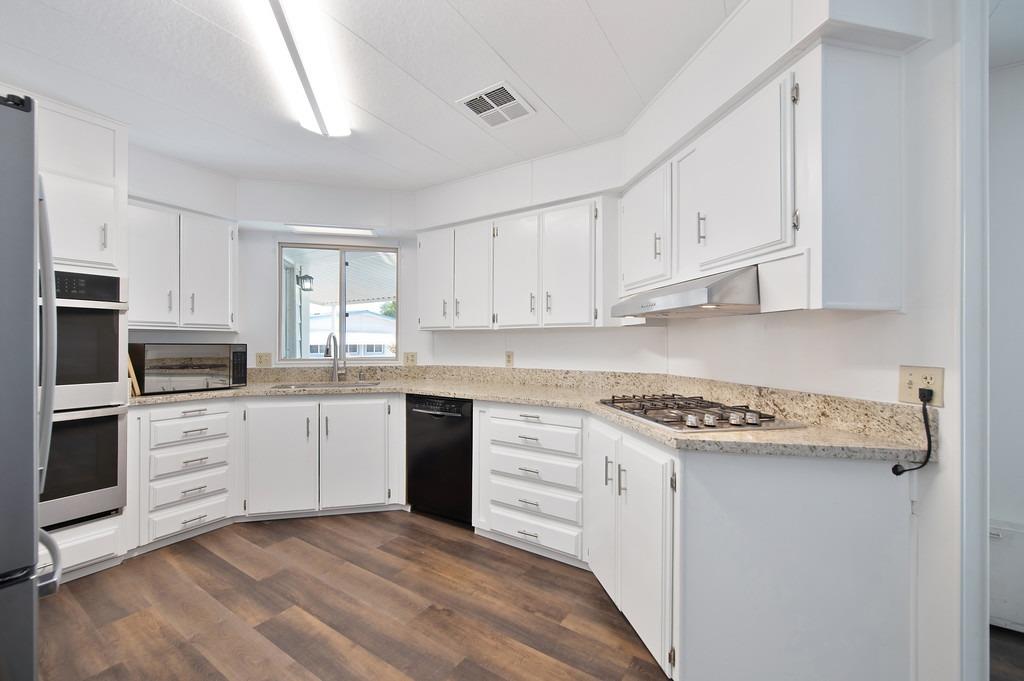 163 Rimma Way Roseville, CA 95661 - Photo 1 of 35 a kitchen with white cabinets and appliances