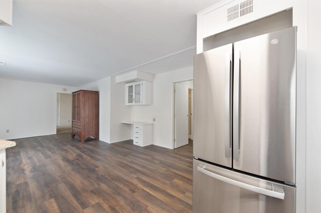 163 Rimma Way Roseville, CA 95661 - Photo 11 of 35 an empty room with wooden floor and windows