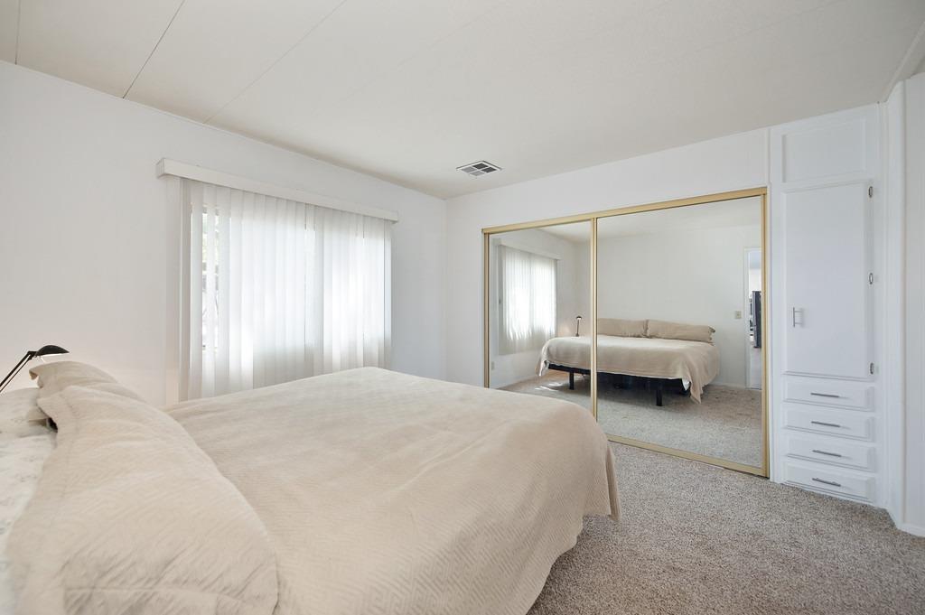 163 Rimma Way Roseville, CA 95661 - Photo 21 of 35 a spacious bedroom with a bed and a window