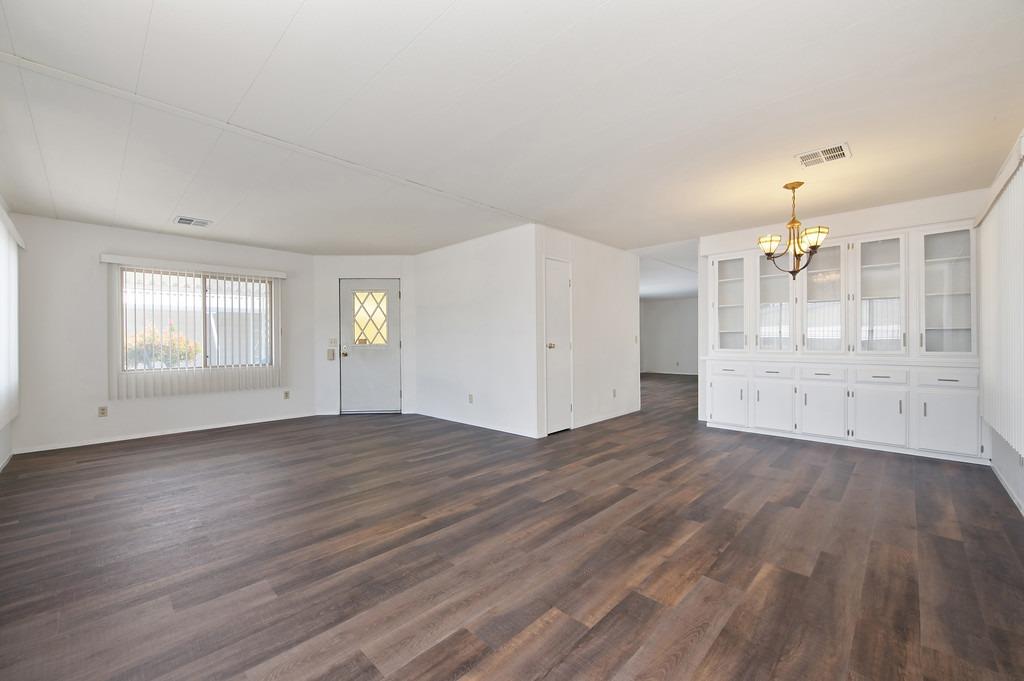 163 Rimma Way Roseville, CA 95661 - Photo 3 of 35 an empty room with wooden floor and windows